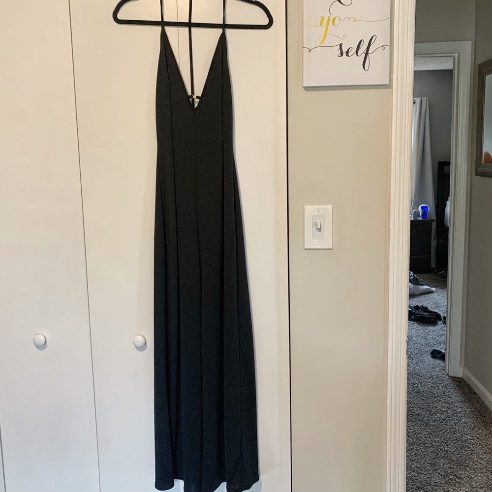 Deep v neck black jumpsuit, wide flowy legs.